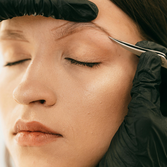 Person Plucking Woman's Eyebrow