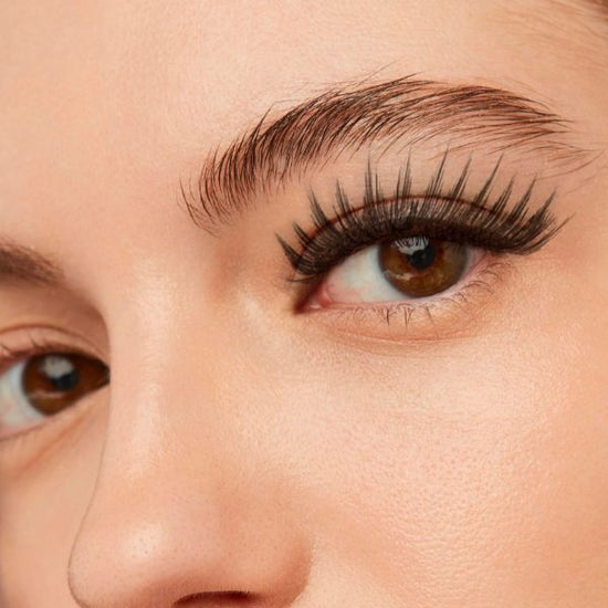 A close look of a woman's eyelashes and eyebrows.