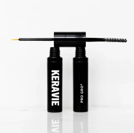 Keravie Professional's Pro Gro2 Lash and Brow Serum in a black double-ended tube with the brush.